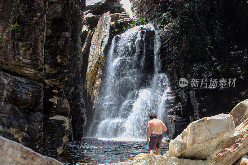 Image of a 43 years old man in front of a waterfall in the Espinhaço mountain range close to Belo Horizonte city, Minas Gerais State , Brazil